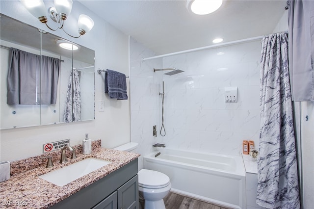 full bathroom with hardwood / wood-style flooring, vanity, toilet, and shower / tub combo