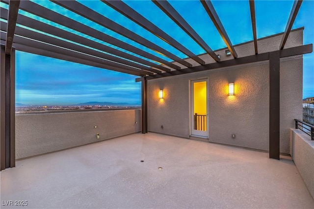 patio terrace at dusk with a pergola