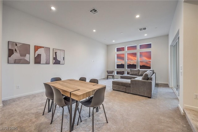 dining room featuring light colored carpet