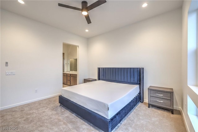 carpeted bedroom with ceiling fan and ensuite bath