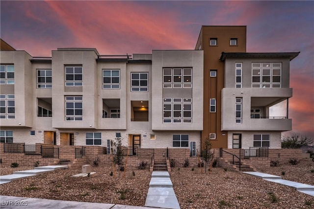 view of outdoor building at dusk