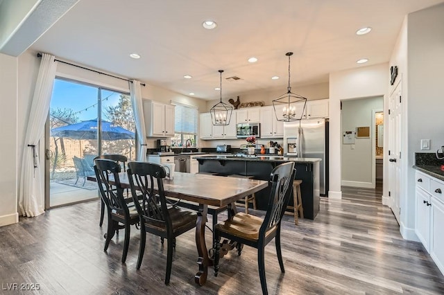 dining area featuring baseboards, a mountain view, dark wood-type flooring, and recessed lighting