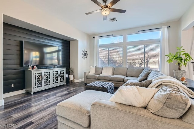 living area with a ceiling fan, baseboards, visible vents, and dark wood-style flooring