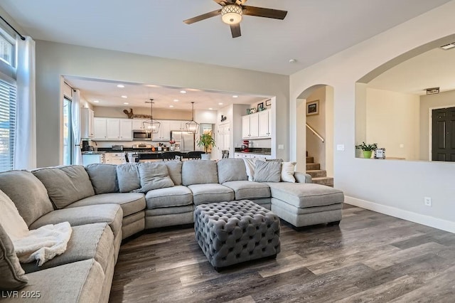 living room featuring dark hardwood / wood-style floors and ceiling fan