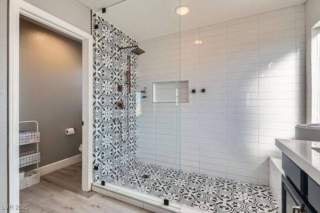 full bathroom featuring toilet, a shower stall, baseboards, and wood finished floors