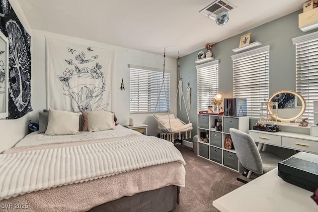 bedroom featuring dark colored carpet and visible vents