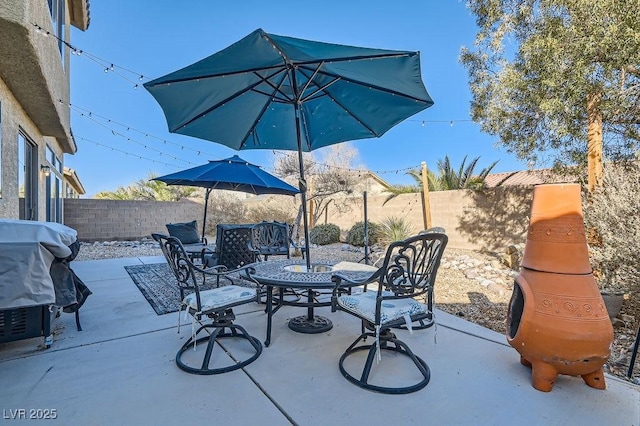 view of patio featuring a fenced backyard and a grill