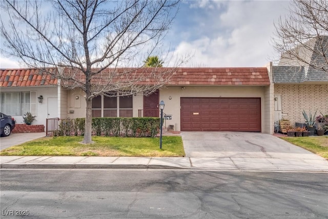 ranch-style house with a garage and a front lawn