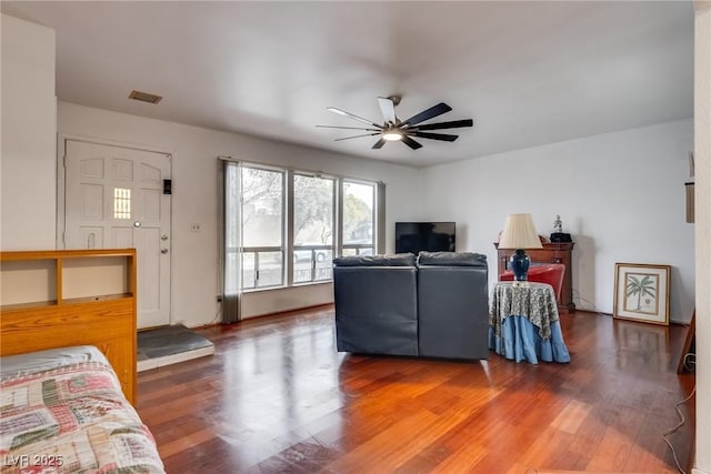 living room featuring hardwood / wood-style flooring and ceiling fan