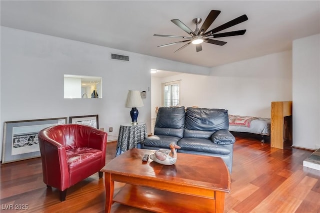 living room with wood-type flooring and ceiling fan