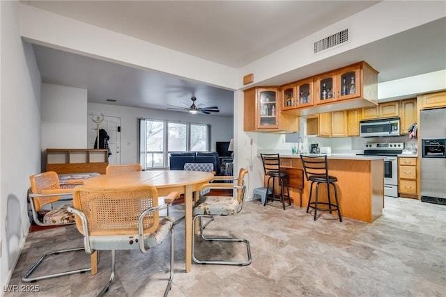 dining room featuring sink and ceiling fan