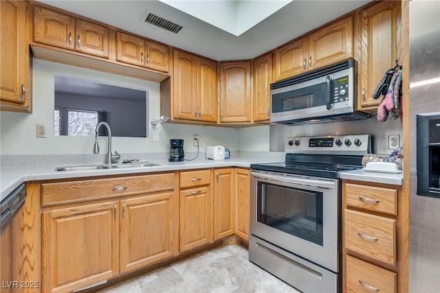 kitchen with sink and appliances with stainless steel finishes