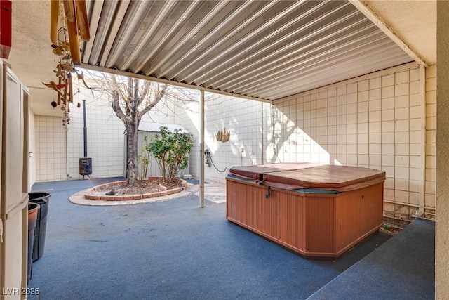 view of patio with a hot tub