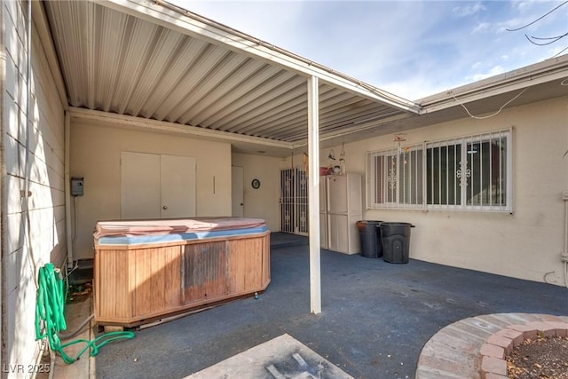 view of patio / terrace with a hot tub