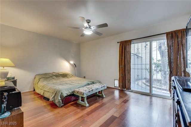 bedroom featuring hardwood / wood-style flooring, ceiling fan, and access to exterior