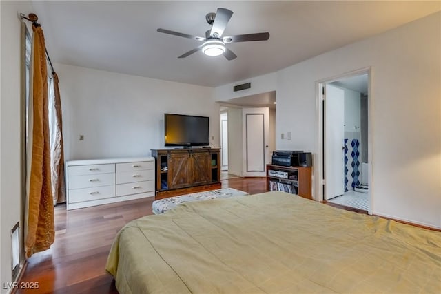 bedroom featuring ensuite bathroom, dark hardwood / wood-style flooring, and ceiling fan