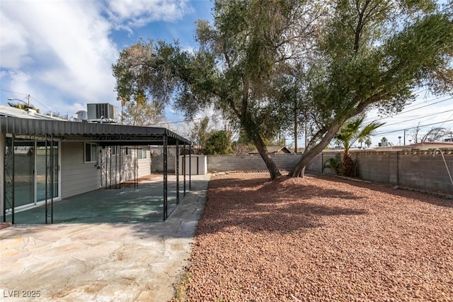 view of yard featuring central AC and a patio