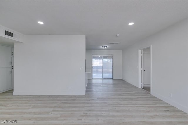 spare room featuring light hardwood / wood-style floors