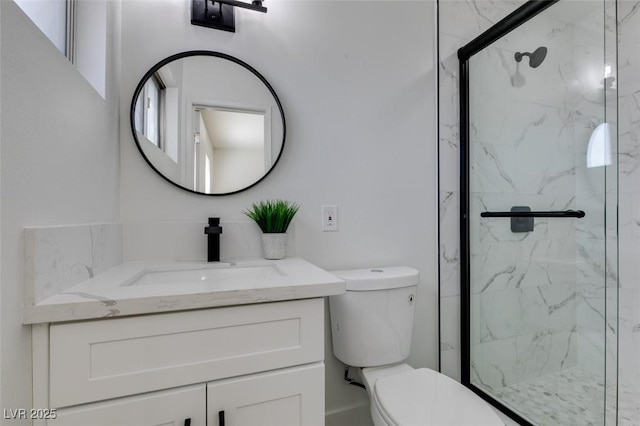 bathroom featuring vanity, toilet, and walk in shower