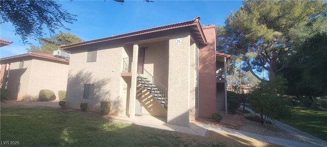 view of property exterior with a lawn