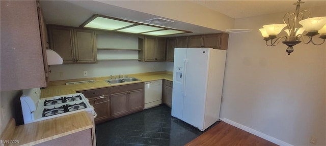 kitchen featuring sink, white appliances, a notable chandelier, ventilation hood, and decorative light fixtures