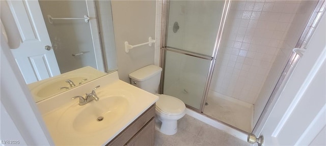 bathroom featuring walk in shower, vanity, toilet, and tile patterned flooring