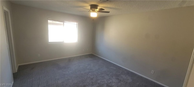 carpeted empty room with ceiling fan and a textured ceiling