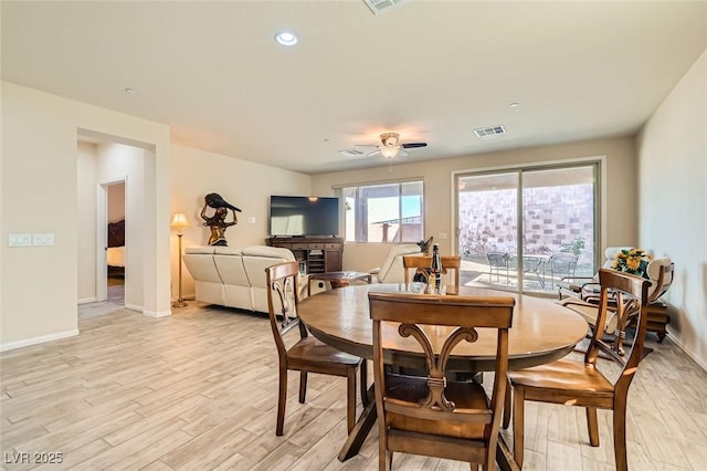 dining area with ceiling fan and light hardwood / wood-style flooring