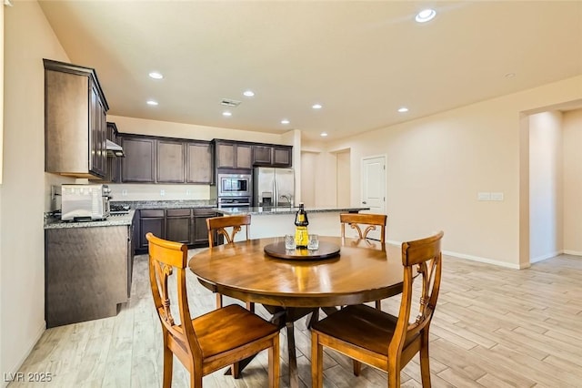 dining room with light hardwood / wood-style flooring