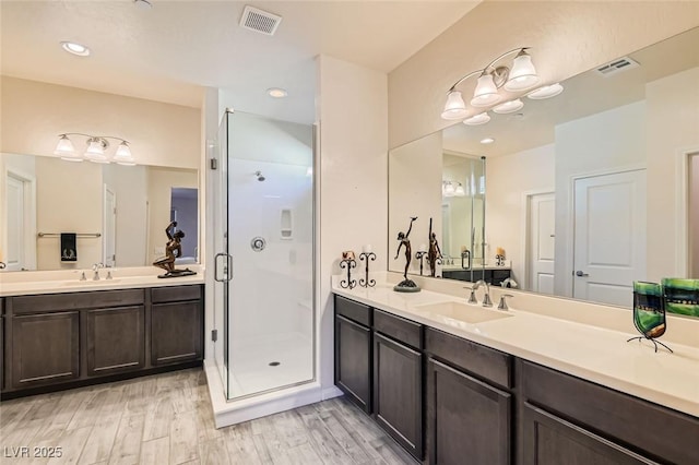 bathroom featuring vanity, hardwood / wood-style floors, and walk in shower