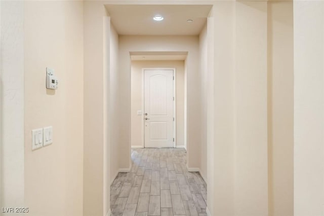 corridor with light hardwood / wood-style floors