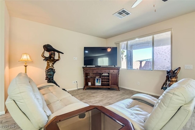 living room with ceiling fan and light wood-type flooring