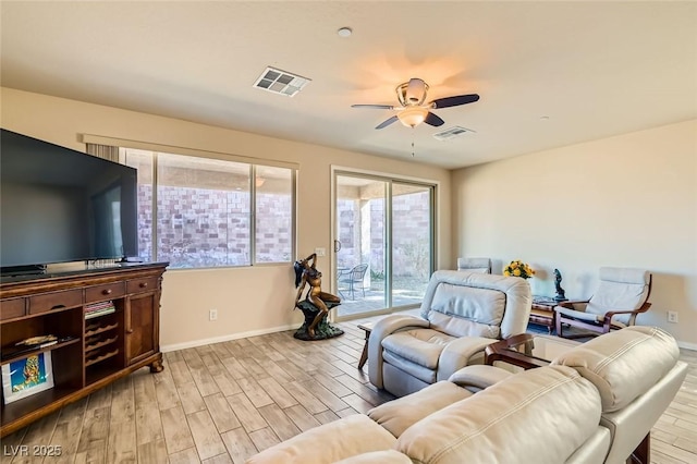 living room with ceiling fan and light hardwood / wood-style floors