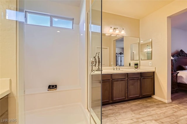 bathroom featuring vanity, wood-type flooring, and a shower