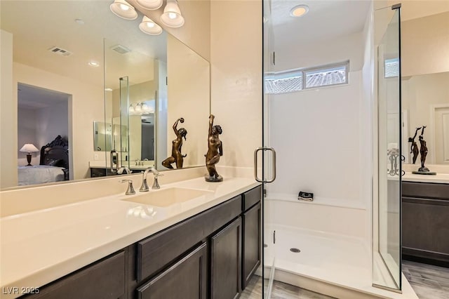 bathroom featuring a shower with door, vanity, and hardwood / wood-style floors