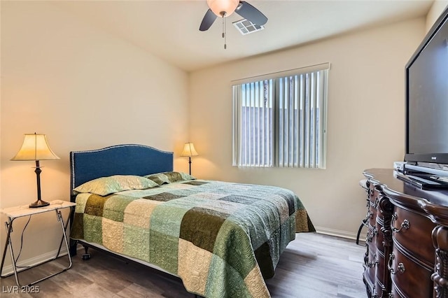 bedroom with ceiling fan and wood-type flooring