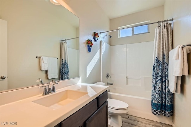 full bathroom with hardwood / wood-style flooring, vanity, shower / bath combination with curtain, and toilet