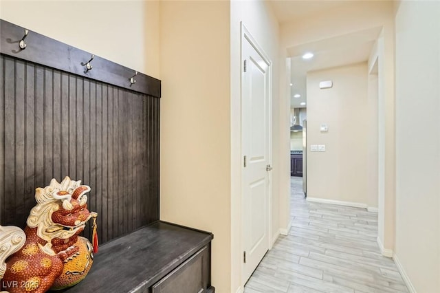 mudroom with light hardwood / wood-style floors