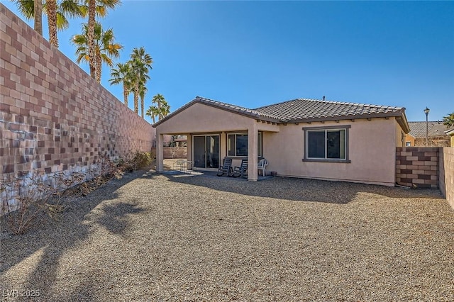 back of property featuring a patio