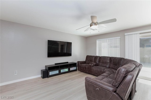 living room featuring ceiling fan and light wood-type flooring