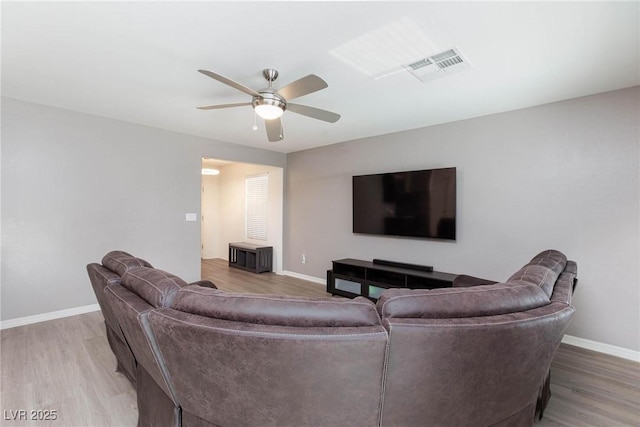 living room with hardwood / wood-style flooring and ceiling fan