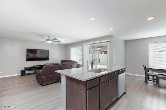 kitchen featuring dishwasher, sink, ceiling fan, dark brown cabinetry, and light hardwood / wood-style floors