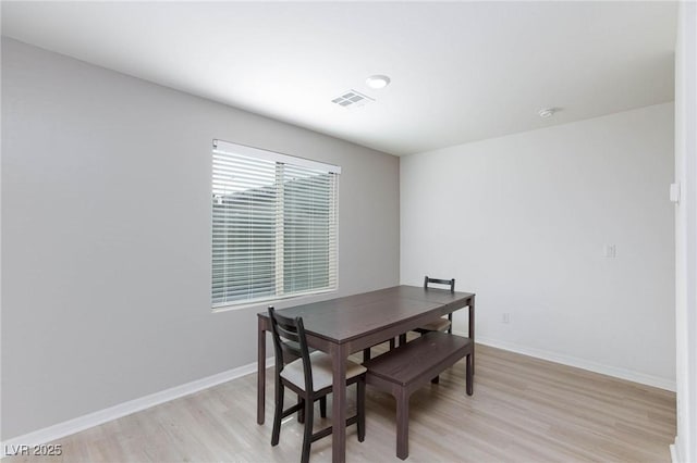 dining space with light hardwood / wood-style floors