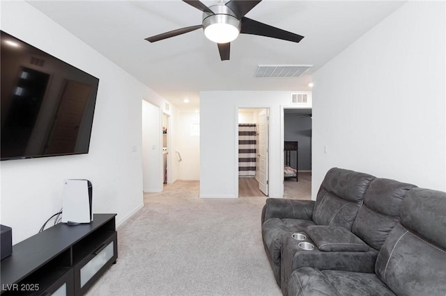 living room featuring light carpet and ceiling fan