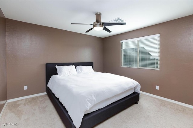 bedroom with ceiling fan and light carpet