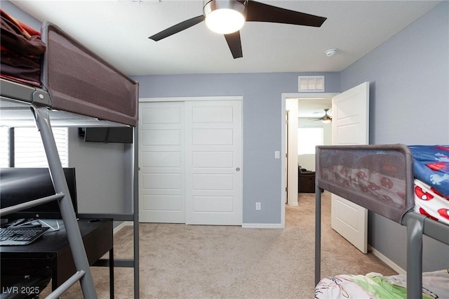 bedroom with light carpet, a closet, and ceiling fan