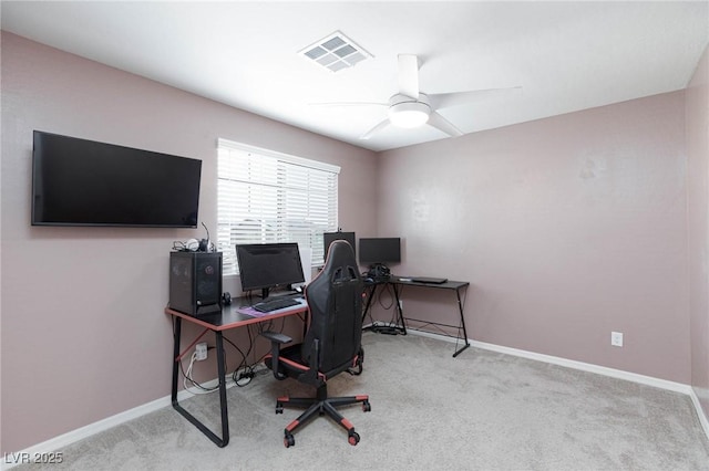 carpeted home office with ceiling fan