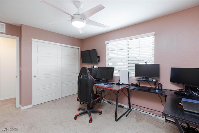 carpeted office featuring ceiling fan