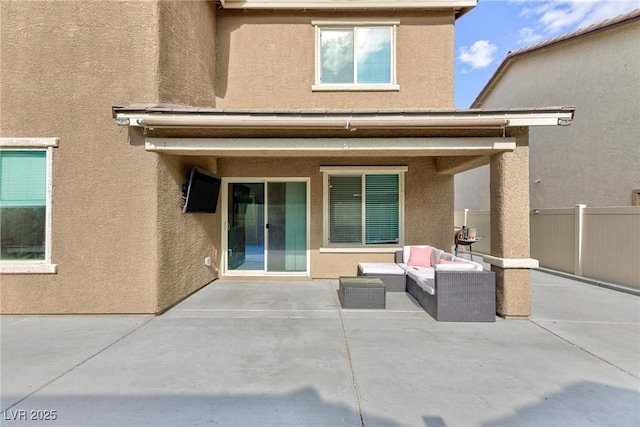 rear view of house with an outdoor living space and a patio area