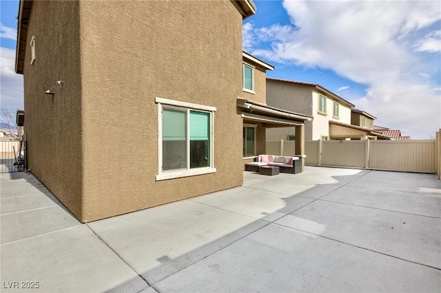 view of side of property featuring outdoor lounge area and a patio